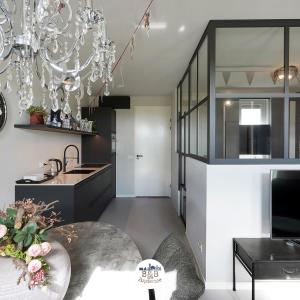 a kitchen and dining room with a chandelier at BB aan de Zuyderzee in Bunschoten