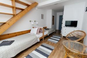 a bedroom with two beds and a tv at Alle Bed & Breakfast in Keszthely