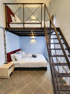 a bedroom with a bunk bed and a staircase at Mac Hotel by Sky Hive in George Town