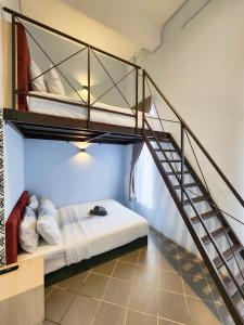 a room with a bunk bed and a staircase at Mac Hotel by Sky Hive in George Town