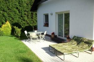 a patio with a couch and a table and chairs at Luxury apartment fireplace + sauna in Stará Paka +23 photos