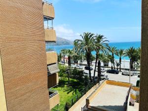 a view of the ocean from the balcony of a building at PLAYA Y PISCINA Intiyan PONDOS in Almuñécar