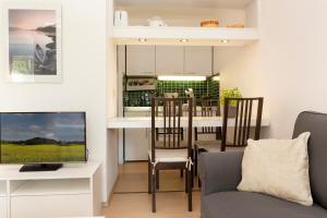 ein Wohnzimmer mit einem TV und einer Küche in der Unterkunft Berolina Wohnung 103 in Dahme