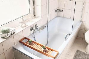 y baño con bañera con 2 plantas. en CosyHomes24 - Workers apartment with parking space - VE01, en Velbert 2 fotos más