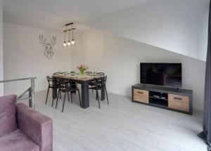 Televízia a/alebo spoločenská miestnosť v ubytovaní Apart Invest Centum Park 21