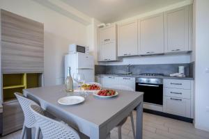 una cucina con tavolo e ciotola di frutta di Appartamento Madeleine a Toscolano Maderno