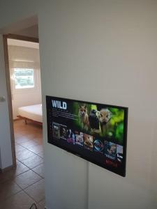 einen Flachbild-TV an der Wand im Wohnzimmer in der Unterkunft Amalthia in Sitia