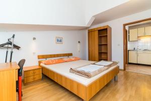 a bedroom with a large bed and a kitchen at Apartments Princ Hrvoje in Dubrovnik