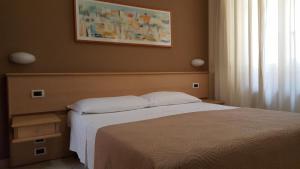 Posteľ alebo postele v izbe v ubytovaní Hotel Astor