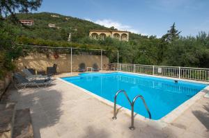 a large swimming pool with a house in the background at Villa Melina in Nisakion