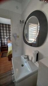a bathroom with a sink and a mirror at Villa Karo in Łeba