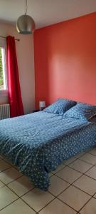 a bed in a bedroom with a red wall at MAISON PROVENCE AVEC PISCINE PRIVATIVE in Nyons +9 photos