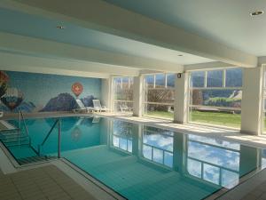 a large swimming pool in a house at Le Chalet Rosat Apartment 25 in Chateau-d'Oex