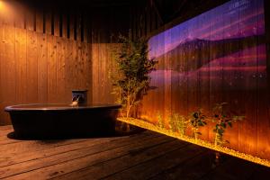 白浜町にある時空間 泉 【白浜最高源泉 甘露の湯】の木製の壁の客室内のバスタブ