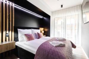 Posteľ alebo postele v izbe v ubytovaní Apartamenty Modrzejewskiej Zakopane