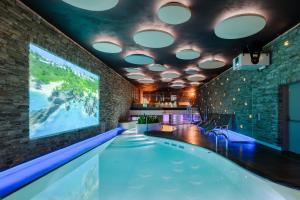 - une piscine dans une chambre avec une grande télévision dans l'établissement Grand Hotel Bristol Spa Resort, by R Collection Hotels, à Rapallo