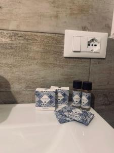 a table topped with boxes and a light with a clock at BOSA HOME B&B in Ceglie Messapica