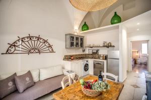 a living room with a couch and a table at Storie e Affreschi - Le Case di Valentina in Gallipoli +23 photos