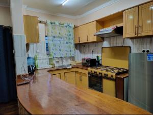 a kitchen with wooden cabinets and a counter top at Fadhili House in Naivasha