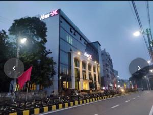 a building on the side of a street at night at Hotel X Rajshahi in Rājshāhi