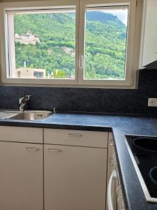 a kitchen with a sink and a window at Schöne grosse Attika-Wohnung im Zentrum von Vaduz inkl. Parkplatz in Vaduz