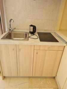 a kitchen counter with a sink and a toaster at Fontana Apartments in Moraitika