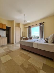 a large bedroom with a large bed and a large window at Fontana Apartments in Moraitika