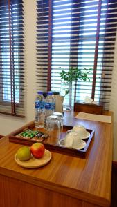 a wooden table with a tray of food and drinks at The Backyard Homestay in Pak Chong