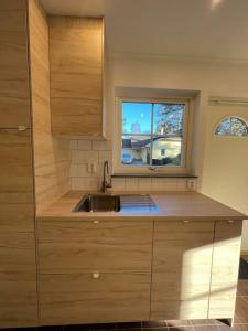 a kitchen with a sink and a window at On your way in Löddeköpinge