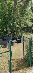 a fence with chairs and tables in a park at On your way in Löddeköpinge