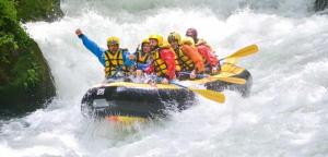 a group of people in a raft in a river at Marmore Charming House in Terni