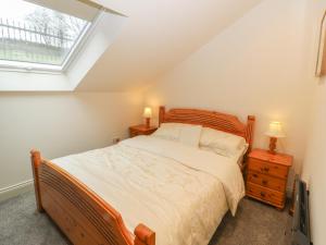 a bedroom with a large bed and a window at Woodlands in Keighley