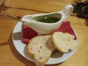 a plate with a bowl of soup and some bread at House ThoNi in Gornji Štoj