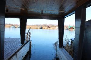 a view from the inside of a house looking at the water at House ThoNi in Gornji Štoj