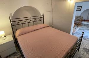 A bed or beds in a room at Trulli Ulivi