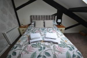a bedroom with a bed with towels on it at 10 Chad Valley in Telford