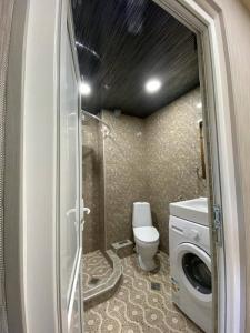 a small bathroom with a toilet and a sink at Bakuriani MIX 401G in Bakuriani
