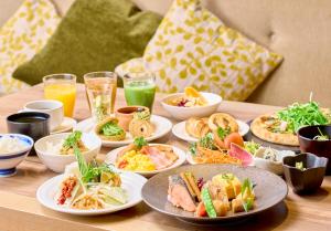 a table topped with plates of food and drinks at Kyoto Tower Hotel in Kyoto