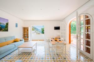 a living room with a couch and a table at Villa Alimede in Positano