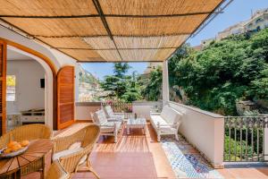 a balcony with chairs and a table on a balcony at Villa Alimede in Positano