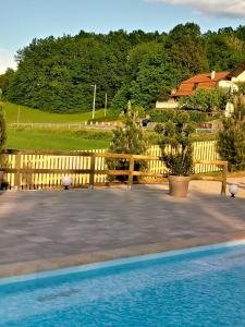 a wooden fence next to a swimming pool at Stella House Mrežnica in Duga Resa