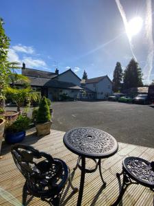 a patio with a table and two chairs and a table at Rooms at The Usk in Talybont