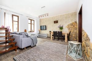 a living room with a couch and a table at Odzieżowa Apartment in Elblag