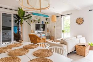 a living room with white tables and chairs at Boho House in Rogowo