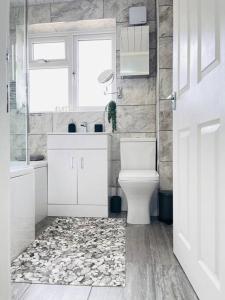 Un baño con inodoro, lavabo y ventana. en Mayfair Place - Cosy 3 Bedroom House with Free Parking, en Birmingham 35 fotos más