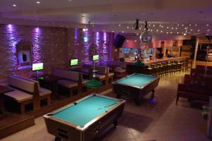 a pool table in a room with a bar at Primavera Beach Hotel Studios & Apartments in Malia