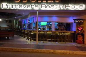 a bar with stools in a restaurant at night at Primavera Beach Hotel Studios & Apartments in Malia