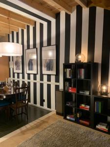 a dining room with black and white stripes on the wall at Largo da Rainha, Guesthouse in Merciana +121 photos