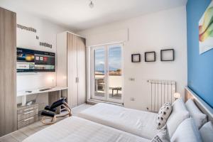 a bedroom with a bed and a desk and a window at Apartment Baccus in Sorrento
