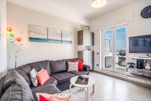 a living room with a couch and a large window at Apartment Baccus in Sorrento